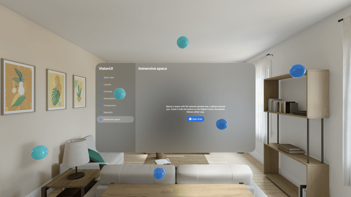 Der Immersive Space: blaue und türkisfarbene Kugeln im Raum verteilt auf unterschiedlichen Höhen, das Galerie-Fenster zeigt einen Hide-Orbit-Button